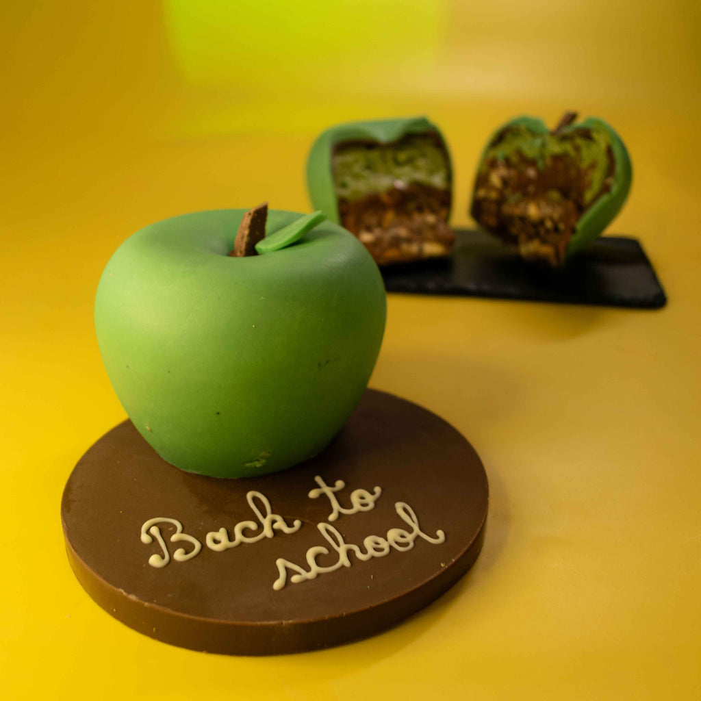 Personalised chocolate apple on a milk chocolate plaque with a name piped in white chocolate