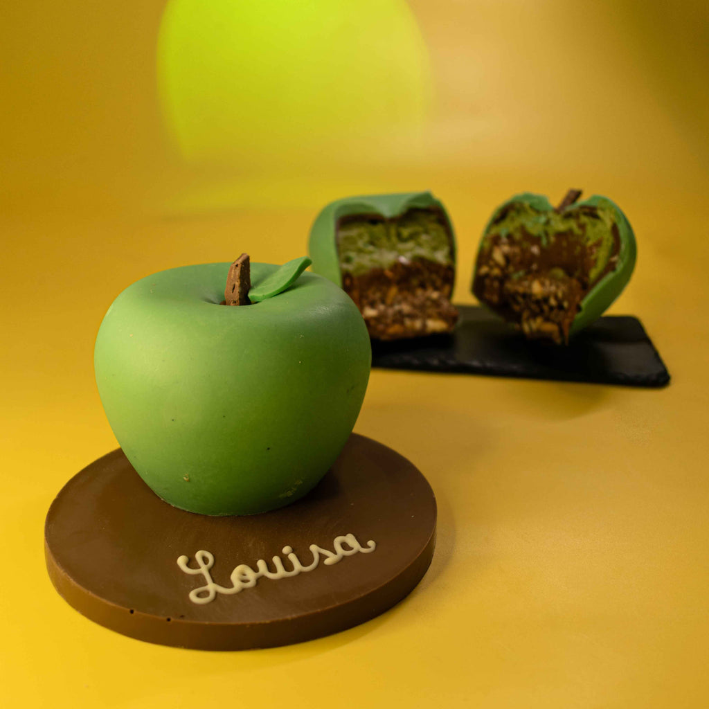 Personalised chocolate apple on a milk chocolate plaque with a name piped in white chocolate